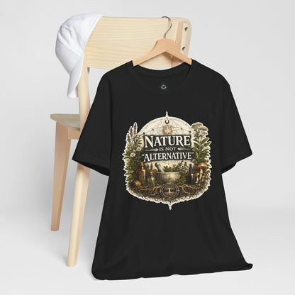 Black Nature Is Not Alternative t-shirt hanging on a wooden hanger with vintage botanical artwork on the front.