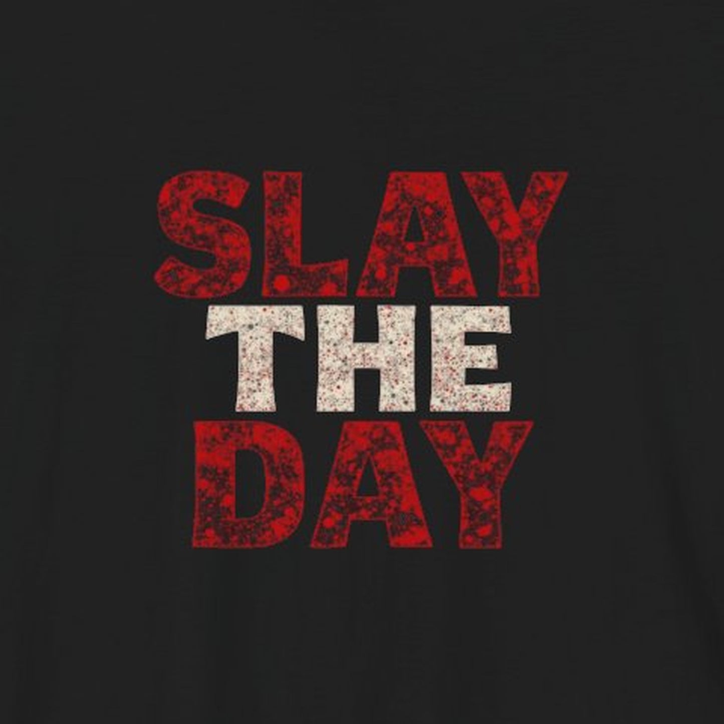 Close-up of Slay The Day distressed red and white lettering printed on black fabric.