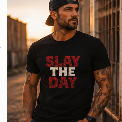 Man wearing black Slay The Day t-shirt in an urban outdoor setting at sunset.