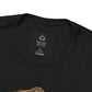 Close-up of black You Can’t Patent God’s Garden t-shirt collar and neck label with partial botanical artwork visible.