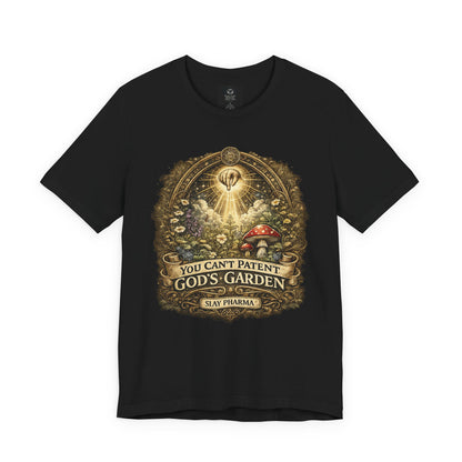Black t-shirt featuring You Can’t Patent God’s Garden artwork with mushrooms, flowers, roots, and radiant sacred garden symbolism.